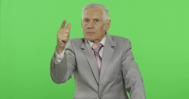 Elderly businessman quarrels at someone threateningly moves with his hand — Stock Video