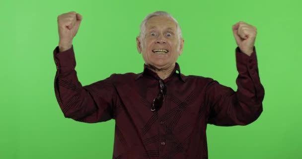 Senior man iets emotioneel vieren. Knappe oude man op Chroma Key — Stockvideo