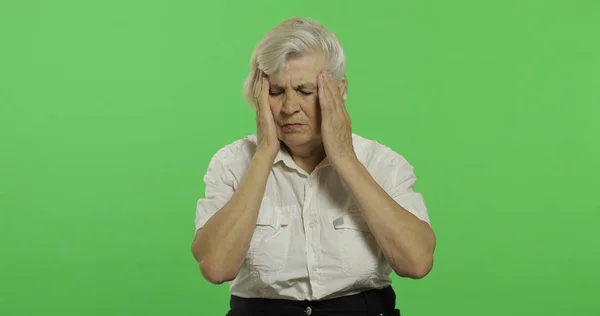 An elderly woman suffer by headache pain trouble. Old grandmother. Chroma key