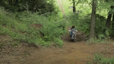 Bolechov, Ukrayna - 12 Temmuz 2019: Ekstrem motosikletçi ormana biniyor