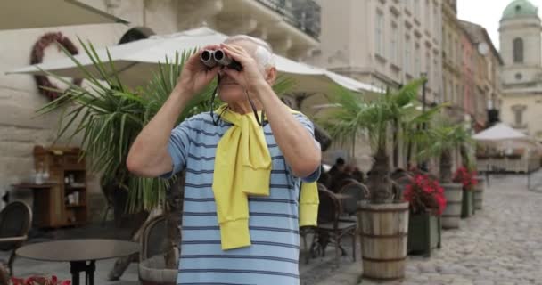 Senior man turist utforska staden. Titta i kikare. Travel Lviv, Ukraina — Stockvideo