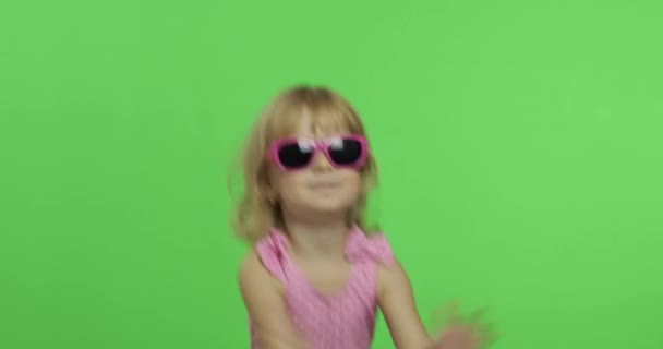 Kind in roze badpak doet sportoefeningen, meisjesfitnesstraining en dansen — Stockvideo