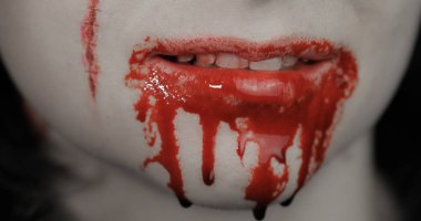 Kanlı ağızlı ve dişli kız. Kan damlayan vampir cadılar bayramı makyajı