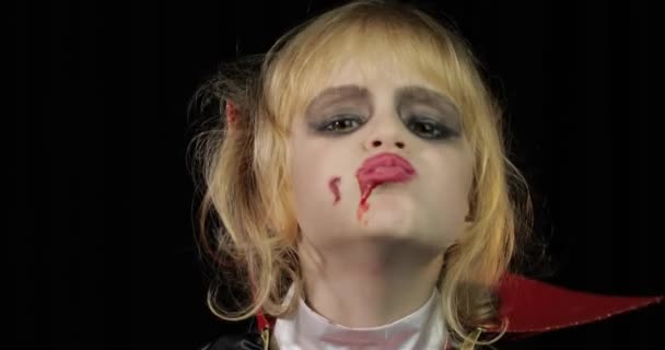 Dracula child. Girl with halloween make-up. Vampire kid with blood on her face — Stock Video