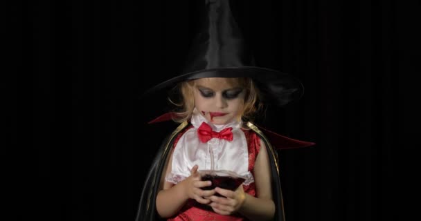 Dracula child. Girl with halloween make-up. Vampire kid with blood on her face — Stock Video