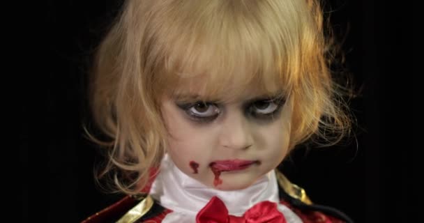 Dracula child. Girl with halloween make-up. Vampire kid with blood on her face — Stock Video