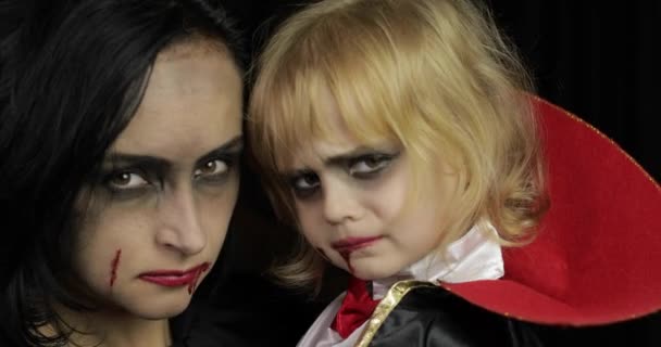 Жінка і дитяча дракула. Хеллоуїн вампір макіяж. Малюк з кров'ю на обличчі — стокове відео