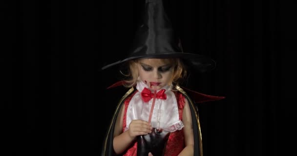 Dracula child. Girl with halloween make-up. Vampire kid with blood on her face — Stock Video