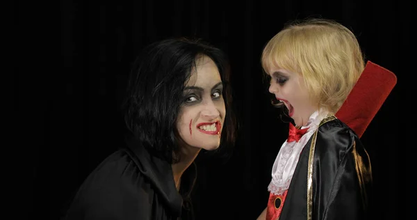 Dracules de femme et d'enfant. Maquillage vampire Halloween. Enfant avec du sang sur le visage — Photo