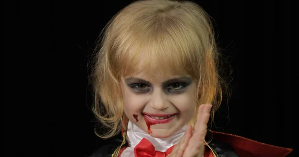 Dracula child. Girl with halloween make-up. Vampire kid with blood on her face — Stock Photo, Image