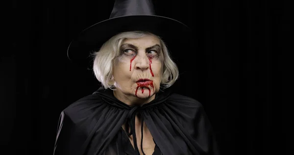 Old witch Halloween makeup. Elderly woman portrait with blood on her face. — Stock Photo, Image