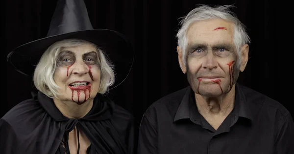 Elderly man and woman in Halloween costumes. Dripping blood on their faces — Stock Photo, Image