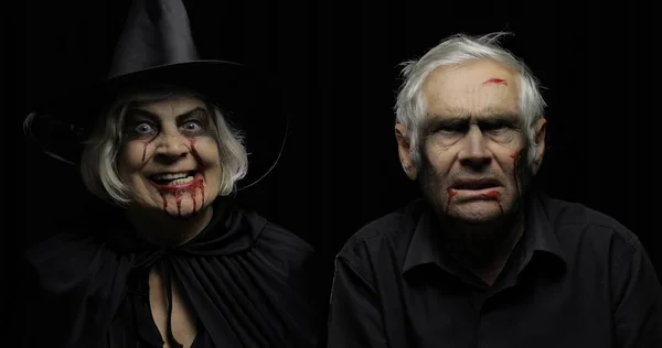 Elderly man and woman in Halloween costumes. Witch and zombie — Stock Photo, Image