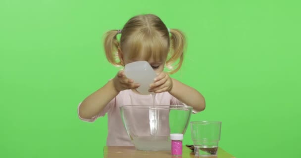 Child having fun making slime. Pour the glue. Kid with hand made toy — Stock Video