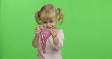 El yapımı oyuncak balçıkla oynayan çocuk. Pembe balçık yaparken eğlenen çocuk