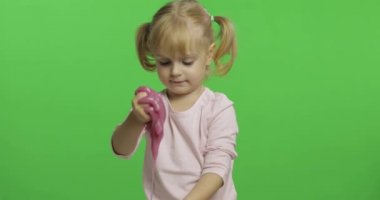 El yapımı oyuncak balçıkla oynayan çocuk. Pembe balçık yaparken eğlenen çocuk