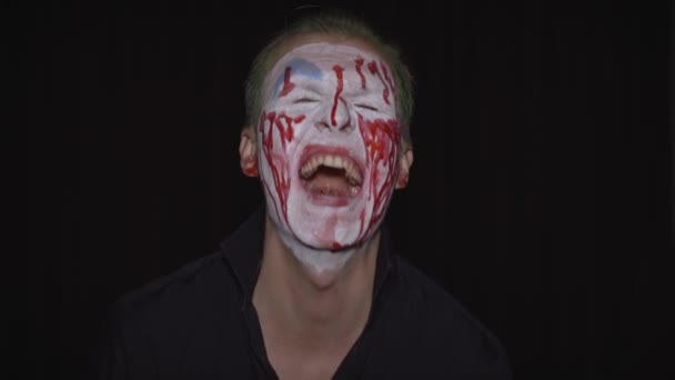 Clown Halloween man portrait. Creepy, evil clowns blood face. White face makeup — Stock Video