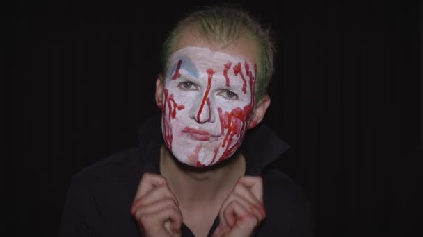 Clown Halloween man portrait. Creepy, evil clowns blood face. White face makeup — Stock Video