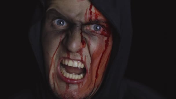 Man executioner Halloween makeup and costume. Guy with blood on his face — Stock Video