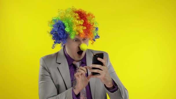 Clown businessman entrepreneur boss in wig losing at work, grabs head. Problems — Stock Video