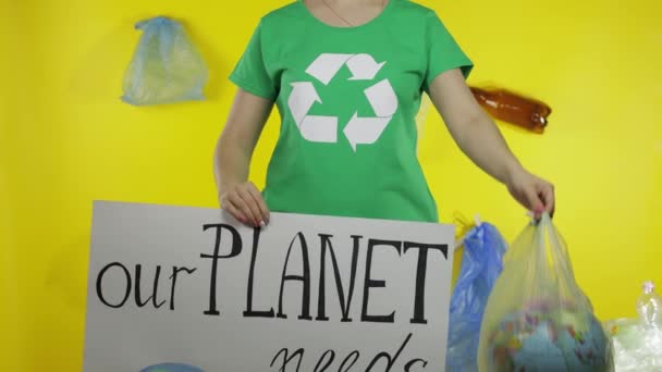 Mujer irreconocible con cartel de protesta y globo terráqueo en paquete de plástico. Contaminación ecológica — Vídeos de Stock