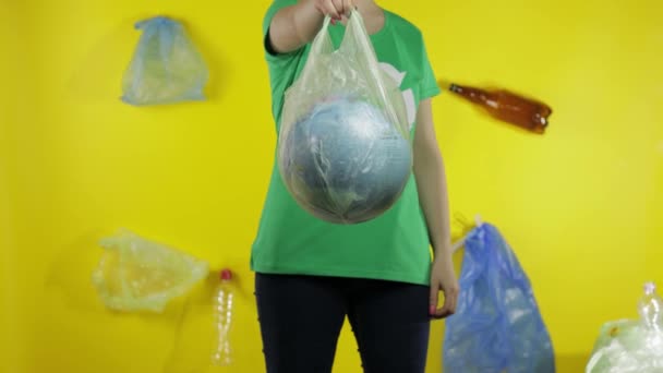 Unrecognizable woman with Earth globe in plastic package. Save ecology. Plastic nature pollution — Stock Video