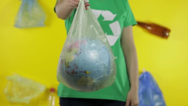 Oigenkännlig kvinna med jordklotet i plastförpackning. Rädda ekologin. Naturföroreningar av plast — Stockvideo