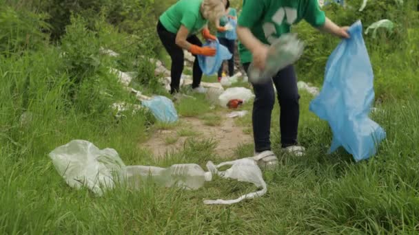 Equipo de voluntarios limpiando el parque sucio de bolsas de plástico, botellas. Reducir la contaminación de celofán basura — Vídeos de Stock