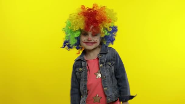Child girl clown in colorful wig dancing with money dollar cash banknotes. Fool around, smiling — Stock Video