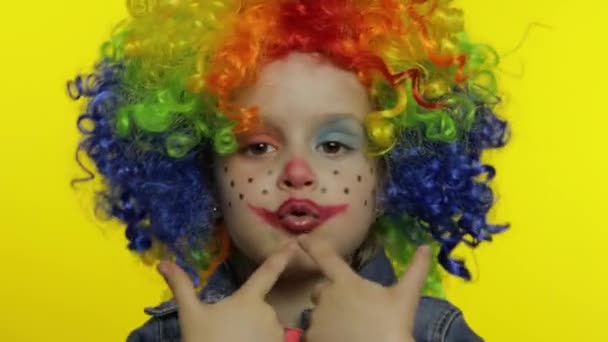 Little child girl clown in wig making silly faces, fool around, shows pistols with hands. Halloween — Stock Footage Little child girl clown in wig making silly faces, fool around, shows pistols with hands. Halloween Stock Footage