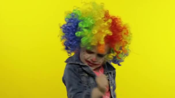Little child girl clown in colorful wig making silly faces, fool around, smiling, dancing. Halloween — Stock Footage Little child girl clown in colorful wig making silly faces, fool around, smiling, dancing. Halloween Stock Video