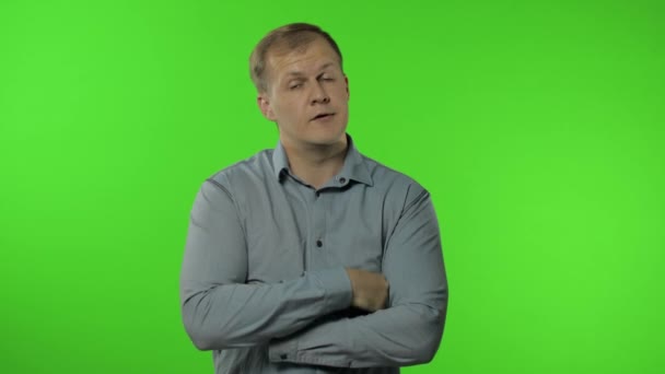 Sleepy bored guy looking at camera not interested in communication. Man on chroma key background — Stock Video