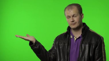 Reklam alanı gösteren bir adam. Şok olmuş görünüyorsun, promosyon metnin için ellerinle işaret ediyorsun, logo
