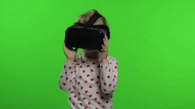 Çocuk kız simülasyon oyun uygulaması için sanal gerçeklik kaskı kullanıyor. Sanal gerçeklik 3D videosunu izle. Krom anahtar