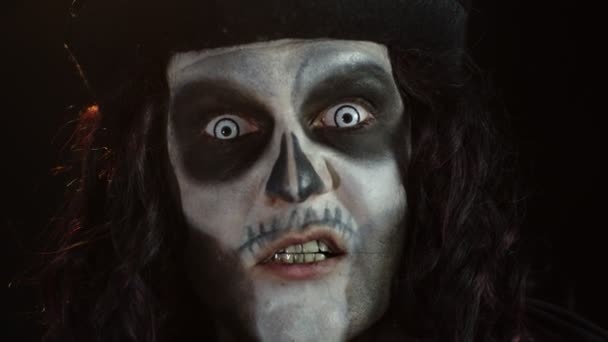 Страшний чоловік у скелеті Хеллоуїн макіяж кричить, кричить, робить обличчя, намагається налякати — стокове відео