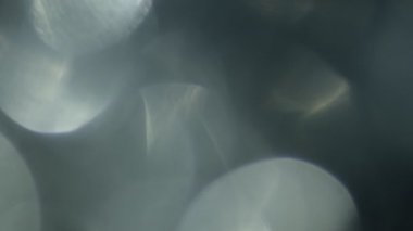 Işık sızıntısı 4K görüntüsü. Lens parlaklığı bokeh örtüleri, yanan alev arka planı. Flaş ışınları etkisi