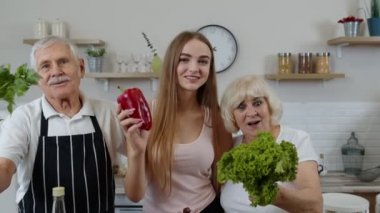 Olgun erkek ve kadının olduğu bir kız çiğ sebze yemeyi öneriyor. Sağlıklı beslenme diyeti