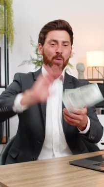 Merkez ofisteki orta yaşlı işadamı, kazandıktan sonra kahkaha atarak havaya dolar atıyor ve eğleniyor. Masadaki serbest çalışan adam parayı paylaşıyor. Maaşı hayır kurumuna bağışta bulunuyor ve takım için küçük hediyeler planlıyor..