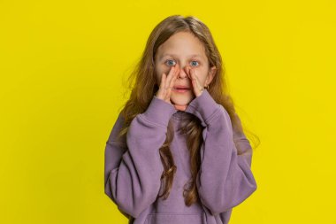 Sırlarımı sakla, sessiz ol. Genç kız çocuk, el ele tutuşup dedikoduları fısıldıyor. Dedikoduları paylaşıyor, sessiz. Sarı arka planda izole edilmiş ilginç, gizli bir hikaye anlatan çocuklar.