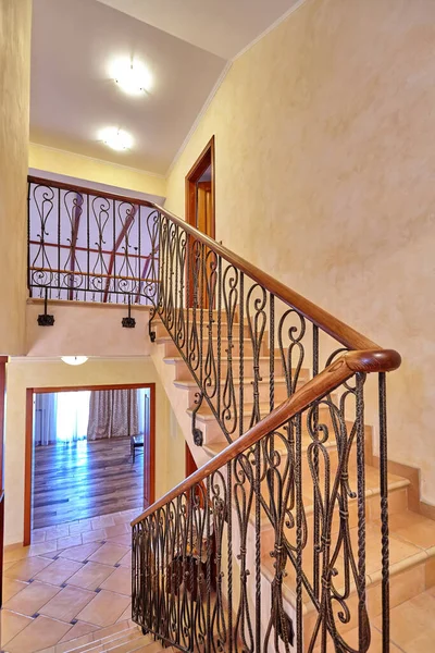 staircase with wrought iron railing