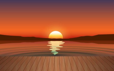 Gün batımında kumsalda tahta köprü manzarası