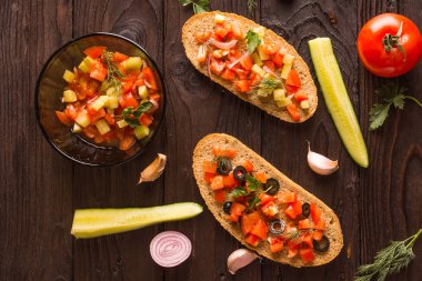 Lezzetli sandviçler ve kahvaltı salata yemek. Zeytin ve domates ve domates, salatalık, zeytin, sarımsak, soğan ve zeytin yağı üzerinden de ne kadar lezzetli salata olarak ekmek üzerinde salatalık domates.