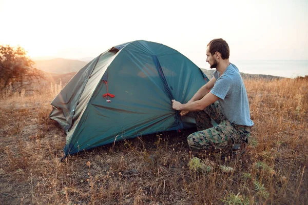 Tourist sets up a tent