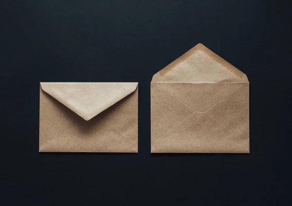 Kraft postal envelopes on a black background.