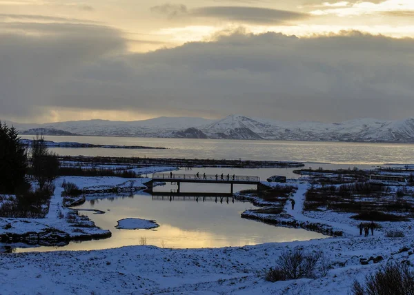 Iceland in spring. The winter landscape covers the the wild countryside and the clouds cover the sunlight.