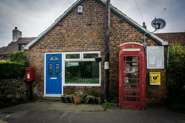 A small english village telephone box and post box against a loc Royalty Free Stock Photos