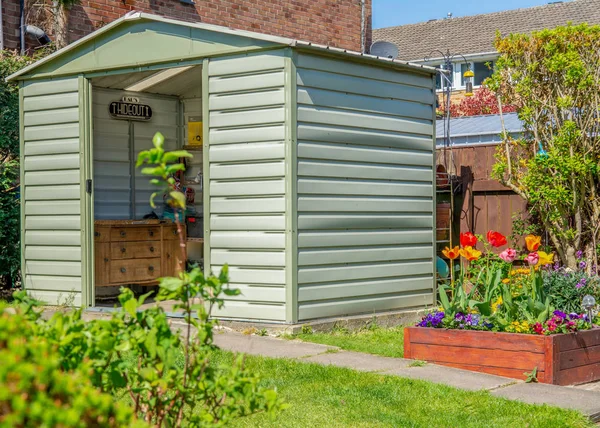 A modern shed and breautiful grden with blooming flowers and a D Stock Image