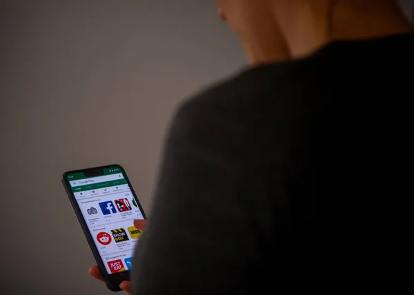 A woman using a Google Pixel 3 Xl  at home . Royalty Free Stock Images