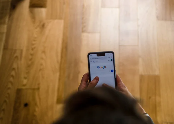 A woman using a Google Pixel 3 Xl  at home . Royalty Free Stock Images