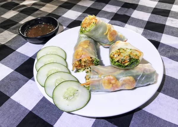 Fresh Handmade Vegetable Spring Rolls On a table. Delicious and healthy Vietnamese rice paper rolls with chicken and vegetables and cucumber.